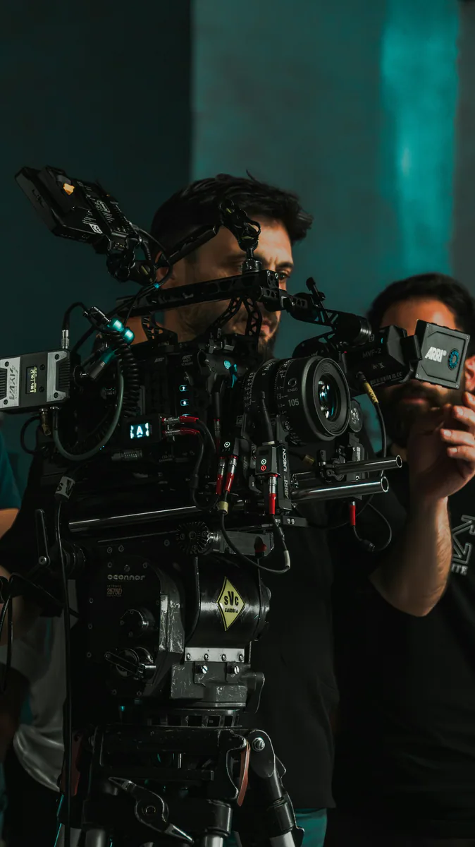 A filmmaker operating a cinema camera on set.