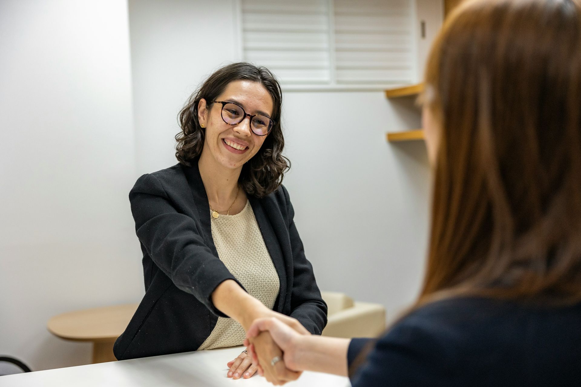 Two people shaking hands after a successful interview